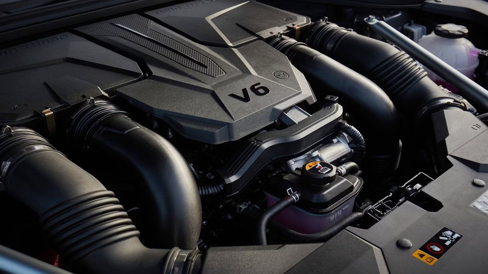 Close-up shot of the V6 engine under the hood of a Genesis GV70.