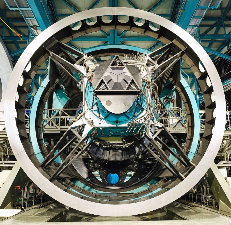 Close-up of a large, complex astronomical telescope structure in an observatory.