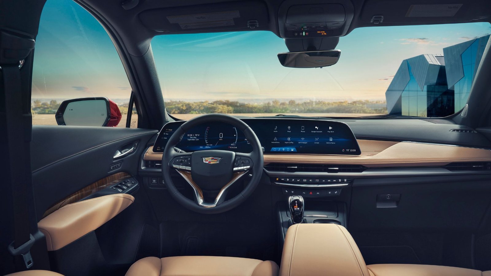 Shot of the interior of the 2025 Cadillac XT4 showing the steering wheel and infotainment display.