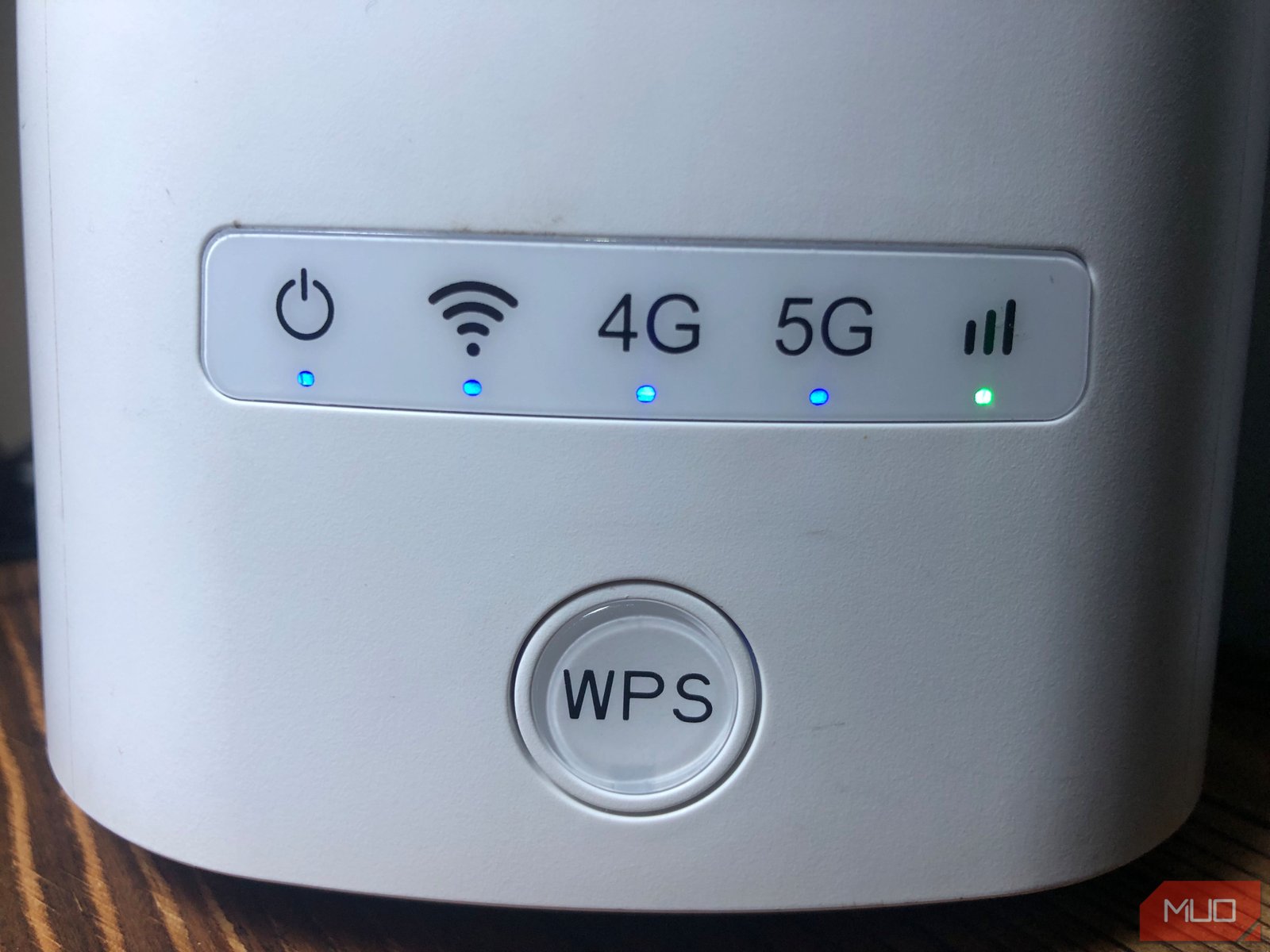 White router with big round WPS button in front of it